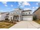 Beautiful two-story home with white trim, dormer windows, and an attached two-car garage at 261 Supernova Dr, York, SC 29745