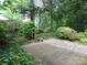Beautiful backyard with brick-paved area, mature trees, and diverse plantings at 2815 Glendale Rd, Charlotte, NC 28209