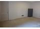 A carpeted basement space suitable for storage and has neutral walls at 2815 Glendale Rd, Charlotte, NC 28209