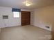 Spacious basement with built-in shelving and carpet, adaptable for various uses at 2815 Glendale Rd, Charlotte, NC 28209