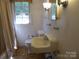 Quaint bathroom features a vintage sink and commode and a shower and tub combo at 2815 Glendale Rd, Charlotte, NC 28209