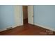 Sunny bedroom with hardwood floors showcasing the doorway to another room at 2815 Glendale Rd, Charlotte, NC 28209