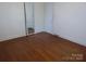 Bedroom with hardwood floors, closet, and mirror providing an open feel at 2815 Glendale Rd, Charlotte, NC 28209