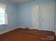 Bright bedroom with hardwood floors and two closets, ready for personalization at 2815 Glendale Rd, Charlotte, NC 28209