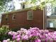 Charming brick home surrounded by vibrant pink azaleas in the garden at 2815 Glendale Rd, Charlotte, NC 28209