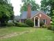 Charming brick home with a landscaped front yard and a stone pathway leading to the front door at 2815 Glendale Rd, Charlotte, NC 28209