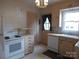 Kitchen featuring white appliances, drawers and a window at 2815 Glendale Rd, Charlotte, NC 28209