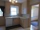 Traditional kitchen featuring light-colored cabinetry, tiled backsplash, and a window over the sink at 2815 Glendale Rd, Charlotte, NC 28209