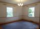 Living room with hardwood floors, natural light from large windows, and classic chandelier at 2815 Glendale Rd, Charlotte, NC 28209