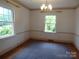 Living room featuring hardwood floors, natural light from large windows, and classic chandelier at 2815 Glendale Rd, Charlotte, NC 28209