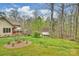 Well-maintained backyard featuring a red deck, lush lawn, and shed bordering a wooded area at 2819 Blythe Rd, Waxhaw, NC 28173
