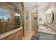 Updated bathroom features granite countertops and glass enclosed shower with seating at 2819 Blythe Rd, Waxhaw, NC 28173