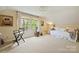 Bedroom featuring a window to view nature, soft carpet, and neutral walls perfect for relaxation at 2819 Blythe Rd, Waxhaw, NC 28173