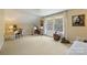 Spacious bedroom with neutral carpet, large window, desk, and music stand; bathed in natural light at 2819 Blythe Rd, Waxhaw, NC 28173