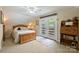 Bright bedroom with a ceiling fan, a wooden trunk at the foot of the bed, and a built-in desk at 2819 Blythe Rd, Waxhaw, NC 28173