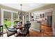 Charming dining area with a view into the modern kitchen and large windows overlooking the backyard at 2819 Blythe Rd, Waxhaw, NC 28173