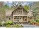 Charming home features a porch with an American flag, beautiful landscaping, and a welcoming entrance at 2819 Blythe Rd, Waxhaw, NC 28173