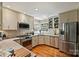 Updated kitchen features granite countertops, stainless steel appliances and hardwood flooring at 2819 Blythe Rd, Waxhaw, NC 28173