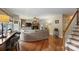 Cozy living room with a fireplace, hardwood floors, comfortable seating, and a staircase at 2819 Blythe Rd, Waxhaw, NC 28173