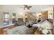 Spacious living room featuring hardwood floors, comfortable seating, french doors, and a view into the kitchen at 2819 Blythe Rd, Waxhaw, NC 28173