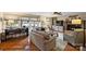 Bright living room with hardwood floors, a stone fireplace, large windows, and comfortable seating at 2819 Blythe Rd, Waxhaw, NC 28173