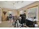 Bright home office featuring two large desks, hardwood flooring, and natural light from three windows at 2819 Blythe Rd, Waxhaw, NC 28173