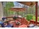 Relax under the shade of the outdoor umbrella on this porch that includes a grill and wooded views at 2819 Blythe Rd, Waxhaw, NC 28173