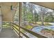 Covered porch features a wooded view, gravel driveway and a hanging light fixture at 2819 Blythe Rd, Waxhaw, NC 28173