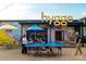 People enjoy a game of ping pong in a vibrant outdoor space with playful murals and casual seating at 3003 Casting St # 12, Charlotte, NC 28206
