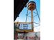 Water tower stands over the community area, framed by colorful shipping containers and event schedules at 3003 Casting St # 12, Charlotte, NC 28206