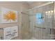 Modern bathroom with a walk-in shower featuring sleek glass doors and neutral tiling at 3100 Azalea Dr, Fort Mill, SC 29707