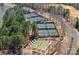 Aerial view of tennis and bocce ball courts surrounded by lush trees, offering recreational amenities at 3100 Azalea Dr, Fort Mill, SC 29707