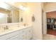 Bright bathroom featuring double sink vanity, large mirror, and walk-in closet at 3102 Arches Bluff Cir, Lancaster, SC 29720