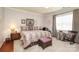 Cozy bedroom with neutral tones, a patterned comforter and a variety of sitting options at 3102 Arches Bluff Cir, Lancaster, SC 29720