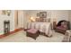 Bedroom featuring neutral tones, patterned comforter, and a small seating area at 3102 Arches Bluff Cir, Lancaster, SC 29720