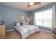 Bedroom featuring a ceiling fan, light blue paint and a large window at 3102 Arches Bluff Cir, Lancaster, SC 29720