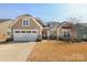 Inviting single-story home with a two-car garage, stone accents, covered entrance and neat landscaping at 3102 Arches Bluff Cir, Lancaster, SC 29720