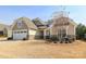 Charming single-story home featuring a two-car garage, stone accents, and manicured landscaping at 3102 Arches Bluff Cir, Lancaster, SC 29720