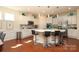 Kitchen featuring white cabinets, stainless steel appliances, tile backsplash and center island at 3102 Arches Bluff Cir, Lancaster, SC 29720