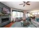 Bright living room with a decorative fireplace, large windows, and comfortable seating arrangements at 3102 Arches Bluff Cir, Lancaster, SC 29720