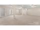 Open basement with arched beams, neutral paint and plush carpeting at 3104 Streamhaven Dr, Indian Land, SC 29707