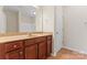 Bathroom with wood vanity, beige countertop, framed mirror, and tiled floor at 3104 Streamhaven Dr, Indian Land, SC 29707
