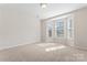 This bedroom offers a large bay window with serene tree line views at 3104 Streamhaven Dr, Indian Land, SC 29707