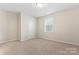 Bedroom with carpeted floor, window and a white door at 3104 Streamhaven Dr, Indian Land, SC 29707