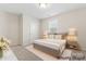 Virtually staged bedroom with natural light, carpeted floor, and neutral tones at 3104 Streamhaven Dr, Indian Land, SC 29707