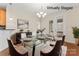 This dining room features a glass table, plush rug, modern chandelier, and access to the outdoor space at 3104 Streamhaven Dr, Indian Land, SC 29707