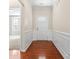 Inviting foyer with hardwood floors, decorative trim, and a view into the adjacent living area at 3104 Streamhaven Dr, Indian Land, SC 29707