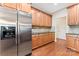 Kitchen featuring stainless steel refrigerator, wooden cabinets, and elegant granite countertops at 3104 Streamhaven Dr, Indian Land, SC 29707