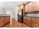 Modern kitchen with stainless steel appliances, wooden cabinets, and granite countertops at 3104 Streamhaven Dr, Indian Land, SC 29707