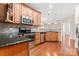 Well-equipped kitchen featuring stainless steel appliances, dark countertops, and hardwood floors at 3104 Streamhaven Dr, Indian Land, SC 29707
